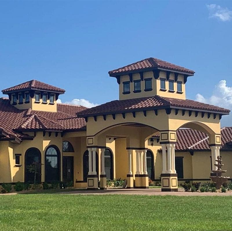Mediterranean-style home with a barrel tile roof and stucco towers