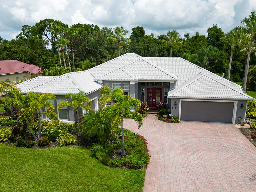 Home with light-colored sustainable roof installed by Noland’s Roofing, showcasing energy-efficient and eco-friendly roofing materials in Florida.