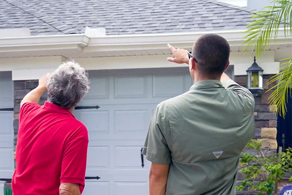 Noland’s Roofing contractor and homeowner inspecting roof damage in Bradenton, FL. Trusted Bradenton roofers serving surrounding Central Florida cities.