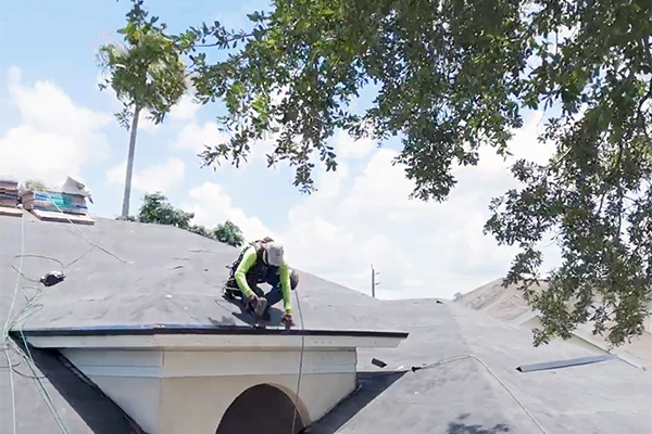 Roofer from Noland’s Roofing works on residential roof installation in Bradenton, Florida, serving nearby cities with expert roofing solutions.