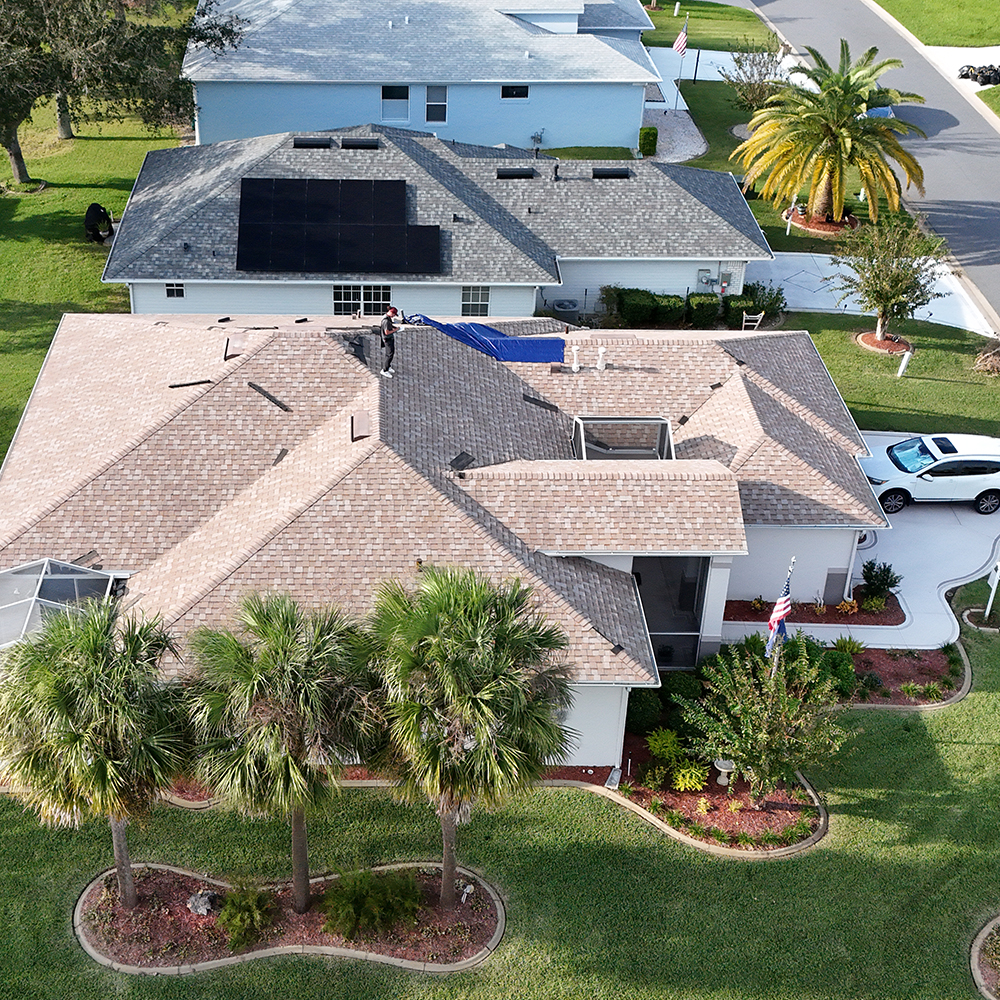 Aerial view of a residential home with light brown shingles, highlighting potential roof leak areas. Noland’s Roofing specializes in roof inspections and repairs, offering a complete guide to identifying and addressing roof leaks in Florida homes.