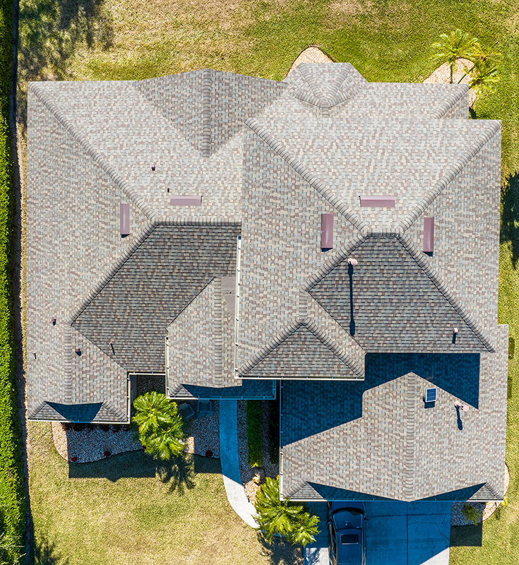 Aerial view of a completed residential roofing project featuring architectural asphalt shingles in Central Florida. Installed by Stanley's Roofing, this high-quality shingle roof showcases clean lines, ridge vents, and precise craftsmanship for maximum durability and curb appeal.
