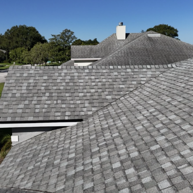 aerial view of a shingle roof with gray shingles after a reroof by Noland's Roofing in Deltona